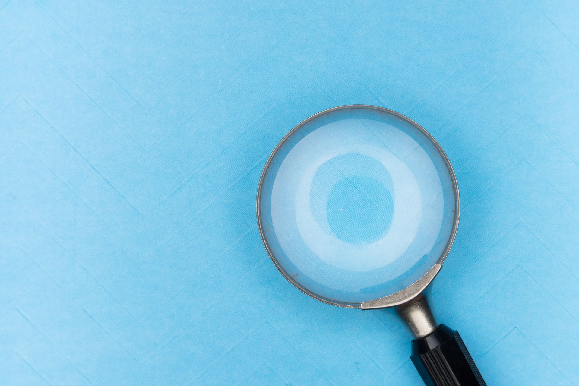 A magnifying glass on a blue background